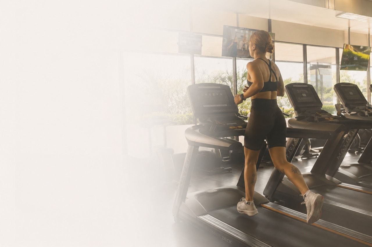 Aneta běží na běžeckém pásu ve fitness centru